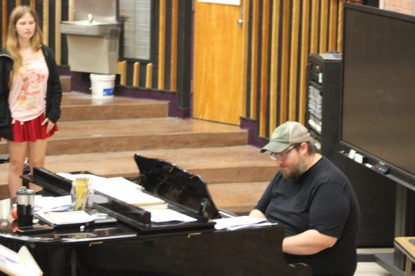 Mr. Cline leads the choir in vocal warm ups