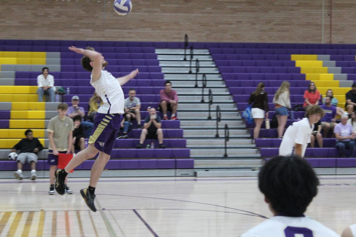 Lance Moody (senior) serves the ball